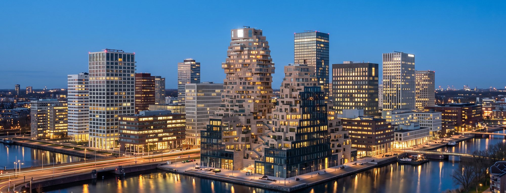 European waterfront business district at blue hour, floors lit and occupied