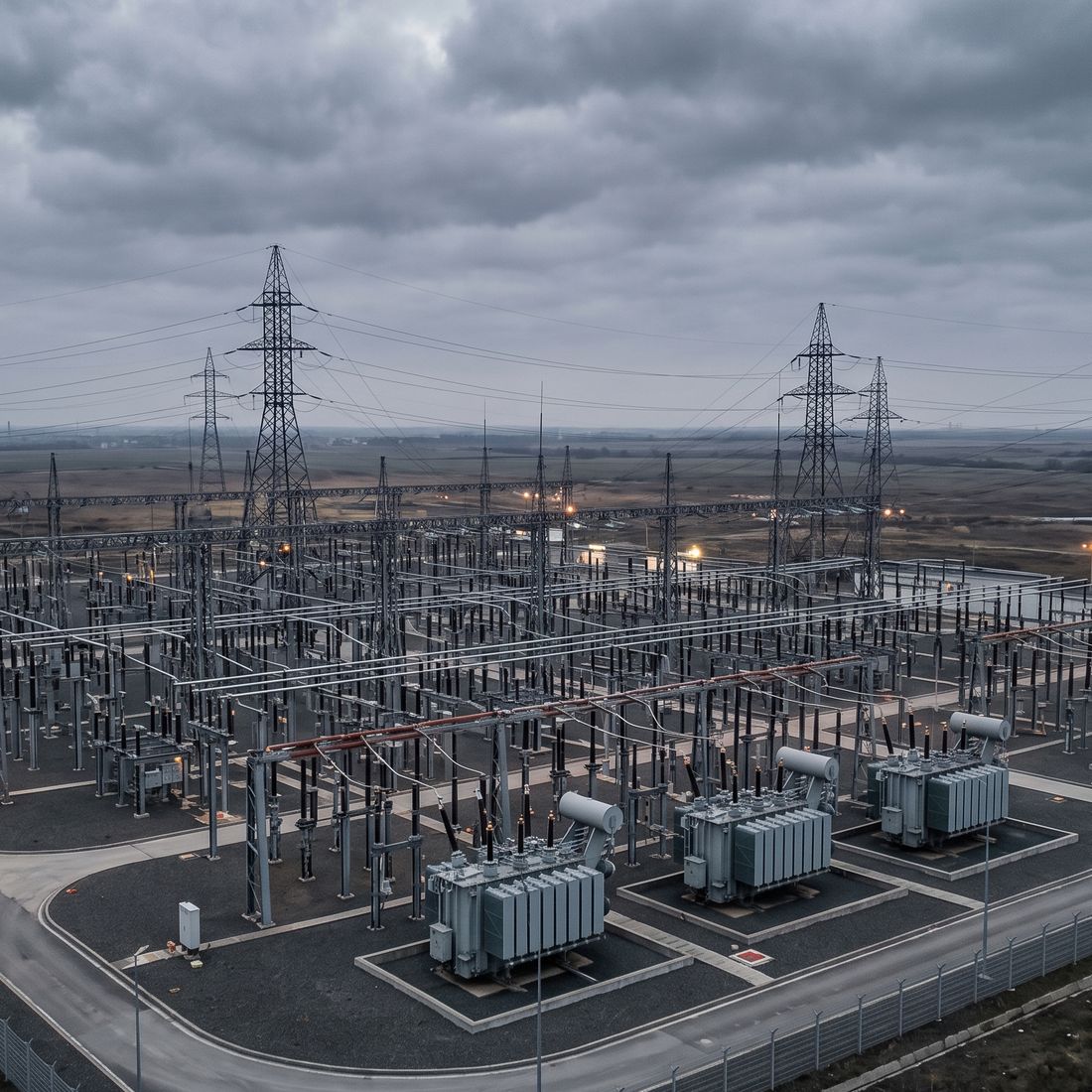 High voltage transmission substation under overcast sky